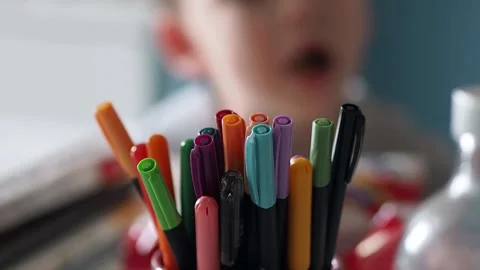 Colored crayons and children, colored pencils in the foreground, Stock Footage 150750671