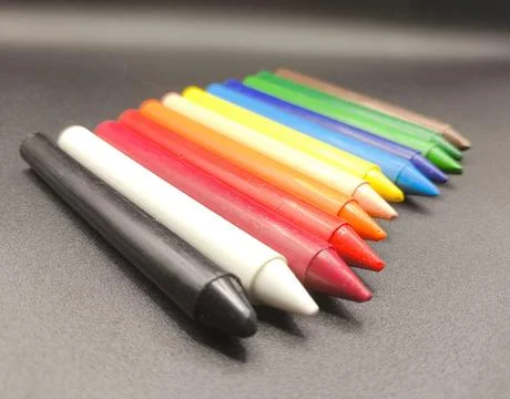 Colored crayons on a black background Stock Photos