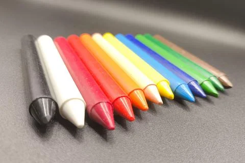 Colored crayons on a black background Stock Photos