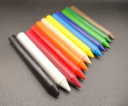 Colored crayons on a black background Stock Photos
