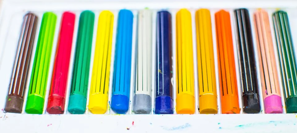 Colored crayons in a box Stock Photos