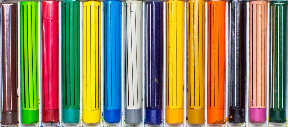 Colored crayons in a box Stock Photos