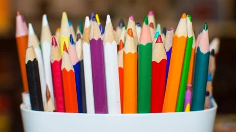 Colored crayons in a box Stock Photos
