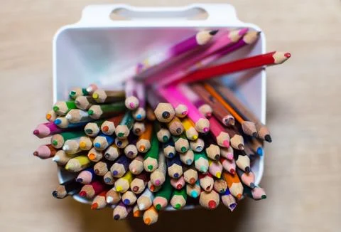 Colored crayons in a box Stock Photos