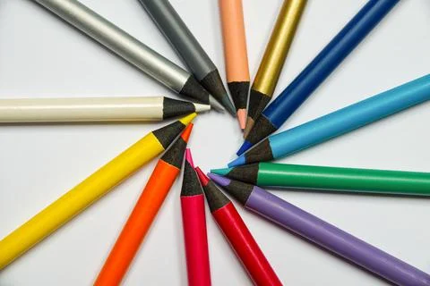 Colored crayons with letters arranged in a circle. Stock Photos