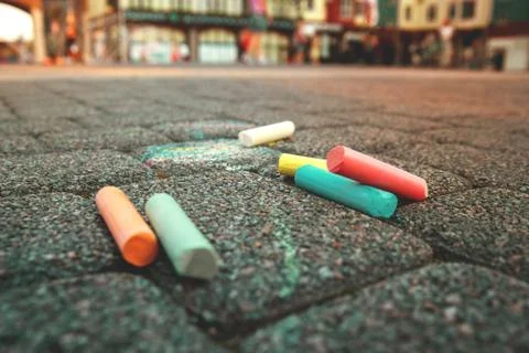 Colored crayons on the pavement, children's creativity, drawing on the street Stock Photos