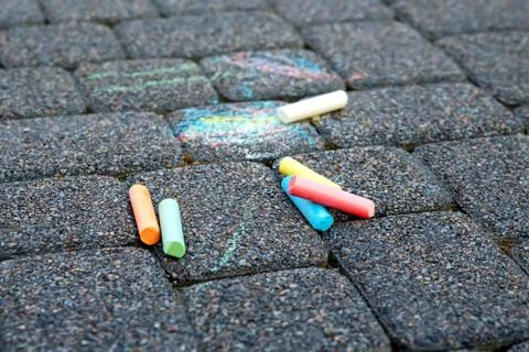 Colored crayons on the pavement, children's creativity, drawing on the street Stock Photos