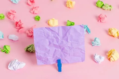 Colored crumpled sheets placed around the empty rectangle square shaped reminder Stock Photos