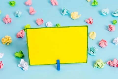 Colored crumpled sheets placed around the empty rectangle square shaped re... Stock Photos