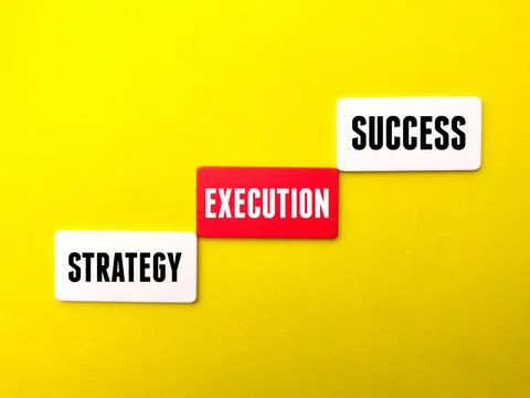 Colored cube written with text Startegy Execution Success on a yellow backgro Stock Photos