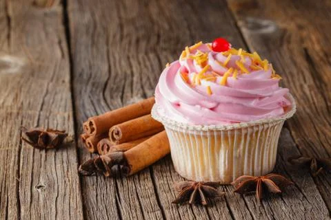 Colored cupcake on rustic background Stock Photos