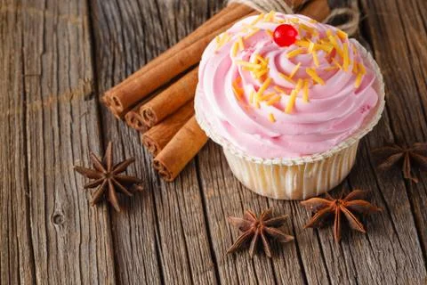 Colored cupcake on rustic background Stock Photos