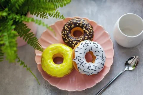 Colored different donuts with icing and topping Stock Photos