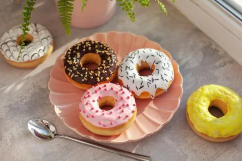 Colored different donuts with icing and topping Stock Photos