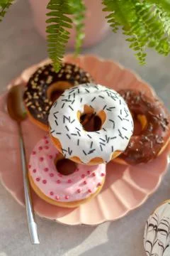 Colored different donuts with icing and topping Stock Photos