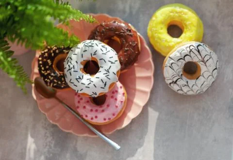 Colored different donuts with icing and topping Stock Photos