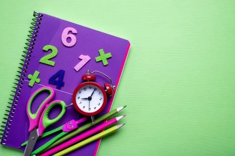 Colored different school supplies on light green paper background. Foto stock