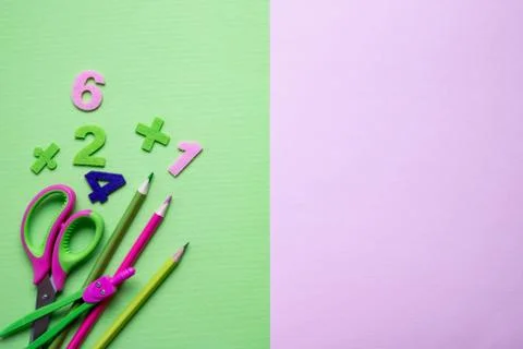 Colored different school supplies on light green paper background. Foto stock