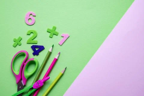 Colored different school supplies on light green paper background. Foto stock