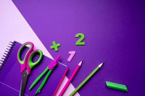 Colored different school supplies on lilac paper background. Back to school Stock Photos