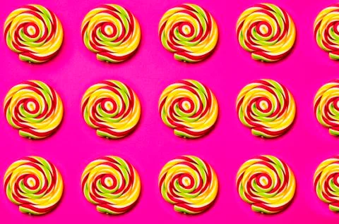 Colored, different sweets, lollipops, marshmallows, caramel popcorn on a pink Stock Photos