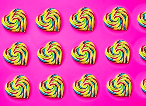 Colored, different sweets, lollipops, marshmallows, caramel popcorn on a pink Stock Photos
