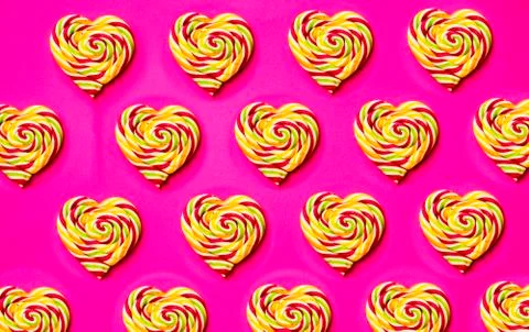 Colored, different sweets, lollipops, marshmallows, caramel popcorn on a pink Stock Photos