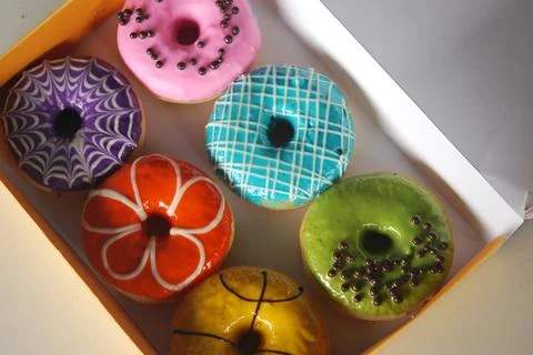 Colored donuts in a box Foto stock