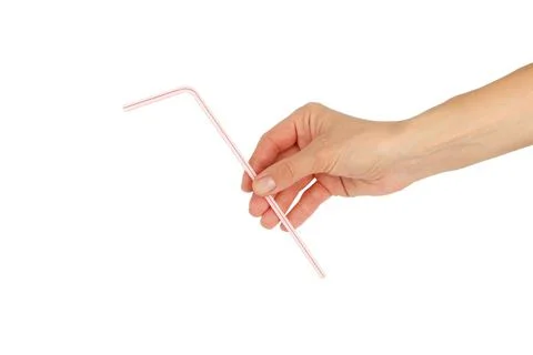 Colored drinking straw in the hand on white background Stock-Fotos