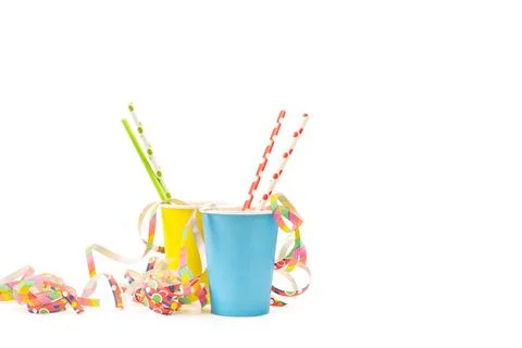 Colored drinking straws in yellow and light blue paper glasses on a white bac Stock Photos