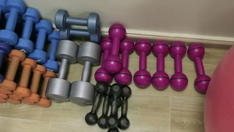 Colored dumbbells in the gym Video stock 73752304