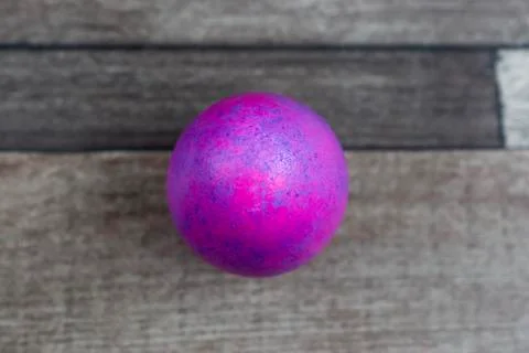 Colored Easter egg on wooden background, top view 库存照片