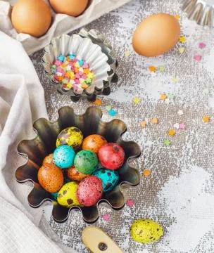 Colored easter eggs and baking molds on a light canvas background,place for t Stock Photos
