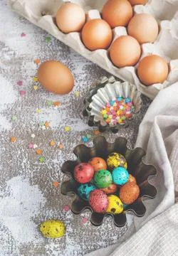 Colored easter eggs and baking molds on a light canvas background,place for t Stock Photos