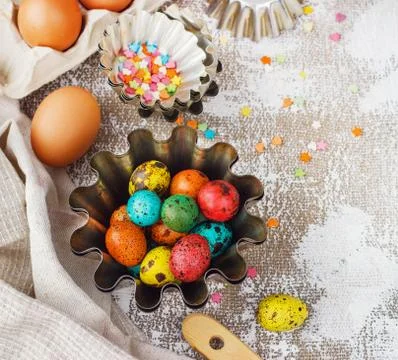 Colored easter eggs and baking molds on a light canvas background,place for t Stock Photos