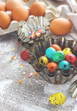 Colored easter eggs and baking molds on a light canvas background,place for t Stock Photos