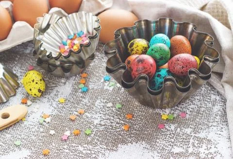 Colored easter eggs and baking molds on a light canvas background,place for t Stock Photos