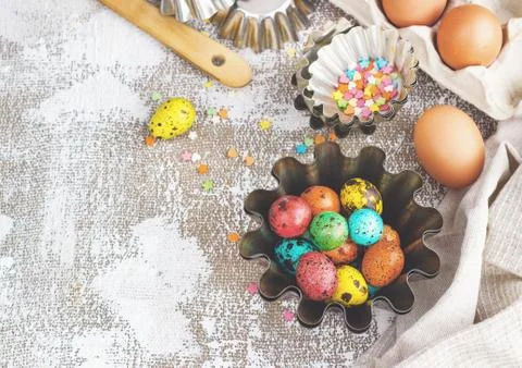 Colored easter eggs and baking molds on a light canvas background,place for t Stock Photos