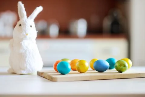 Colored Easter eggs and cute bunny on table on Easter day Foto stock
