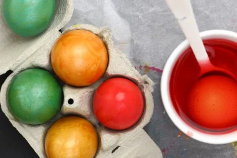 Colored Easter eggs and liquid color dye Stock Photos