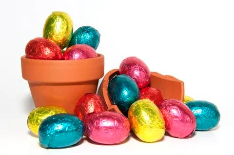 Colored easter eggs and terracotta flower pot Stock Photos