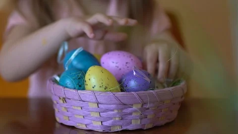 Colored easter eggs in a basket and children's hands close up Stock Footage 104994309