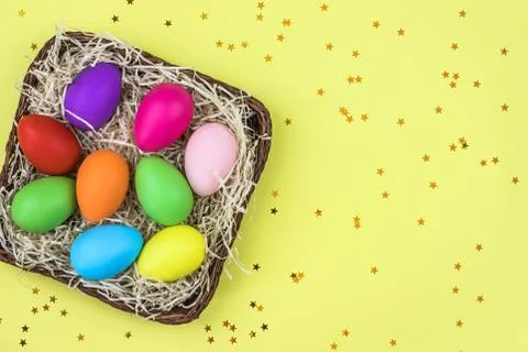 Colored Easter eggs in the basket. Flatlay. Stock-Fotos