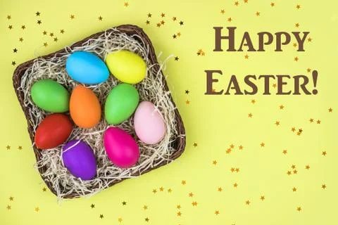 Colored Easter eggs in the basket. Flatlay. Stock Photos