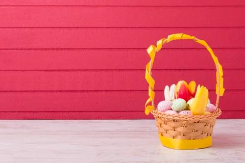 Colored Easter eggs in the basket Stock Photos