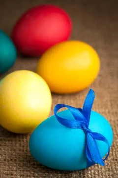 Colored Easter eggs on the burlap background Stock Photos