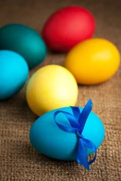 Colored Easter eggs on the burlap background Stock Photos