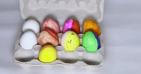 Colored Easter eggs in cardboard box, person hand open it Stock Footage 270159214