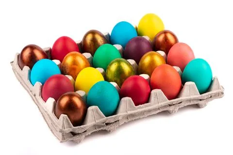 Colored Easter eggs in cardboard boxes on a white background. Stock Photos