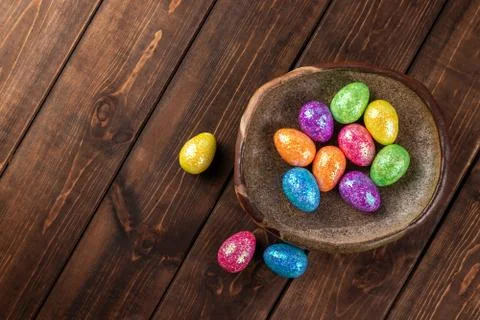 Colored easter eggs on a clay plate. holiday concept with copy space, top vie Stock Photos